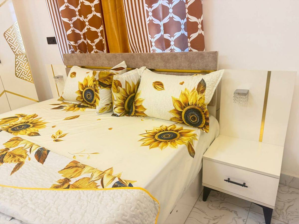 Bed with sunflower bedding and side table