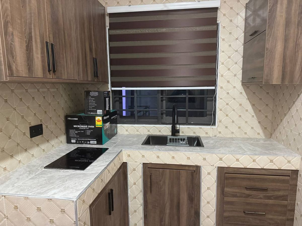 Kitchen with sink, hob and cabinets