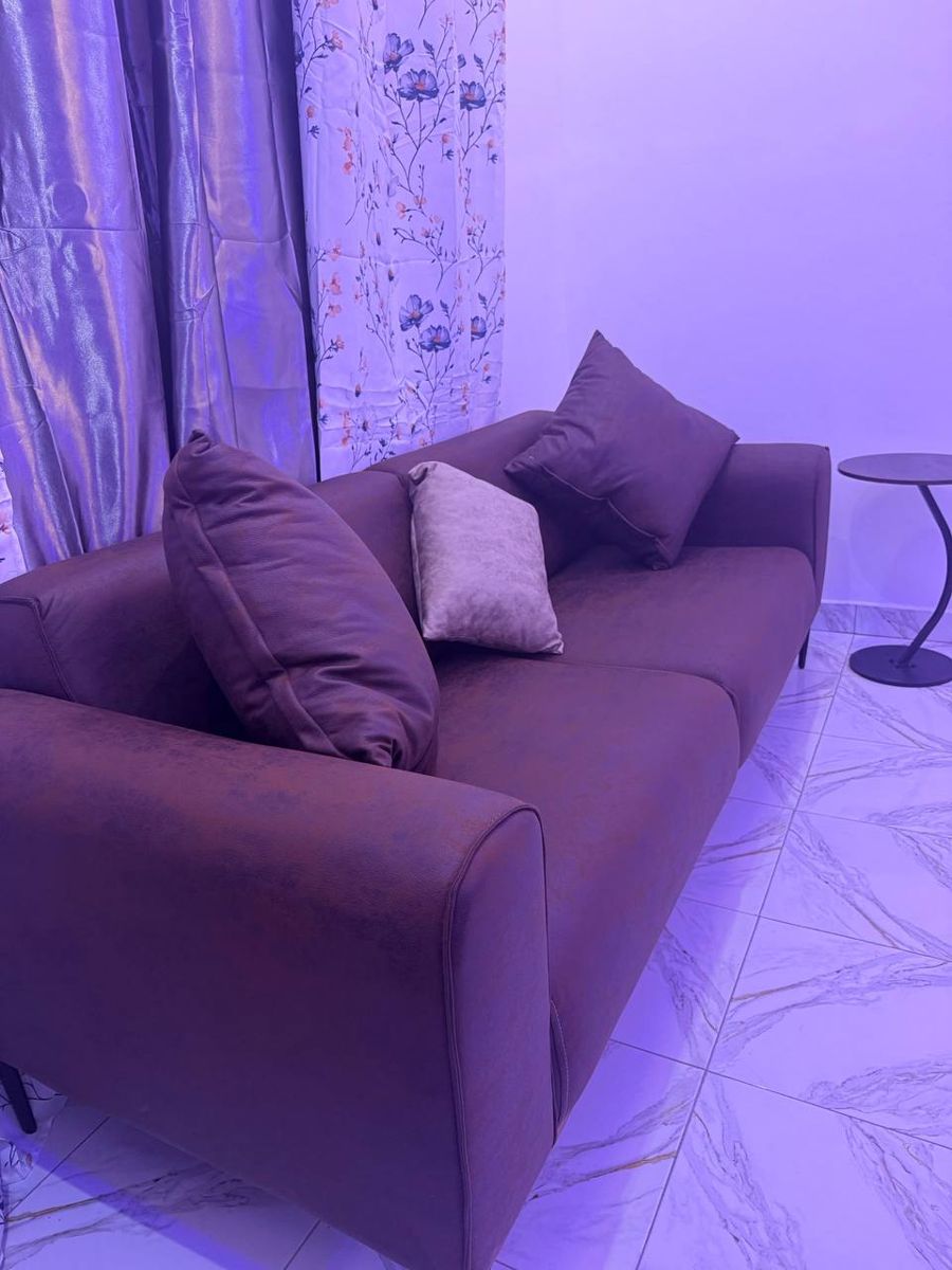 Sofa with cushions by the window